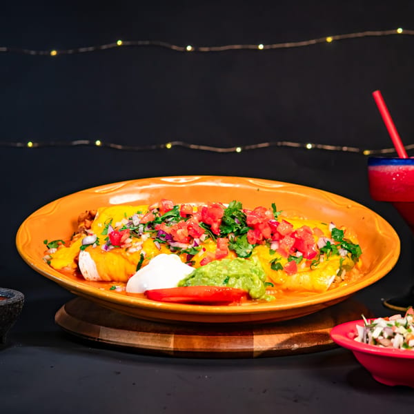 El Mirador 2 enchiladas with cheese, pico de gallo, guacamole, and sour cream, with a margarita.