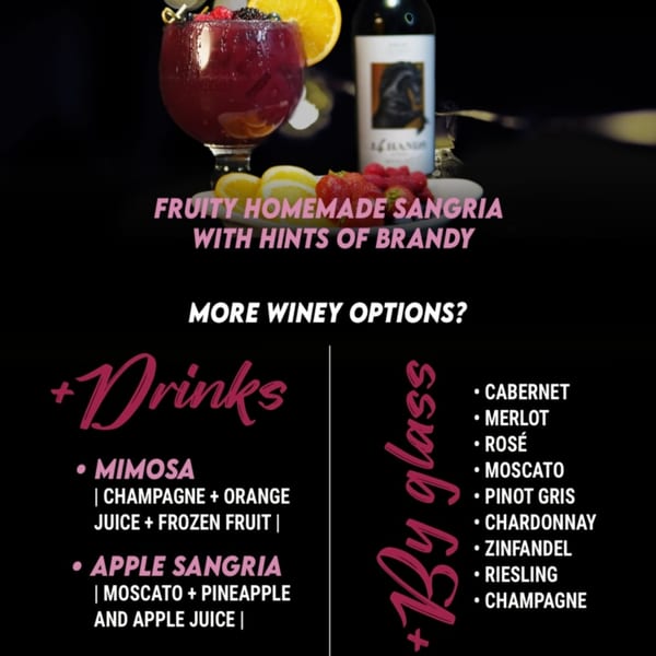 A glass of red sangria with fruit, a wine bottle, and a menu of drink options.
