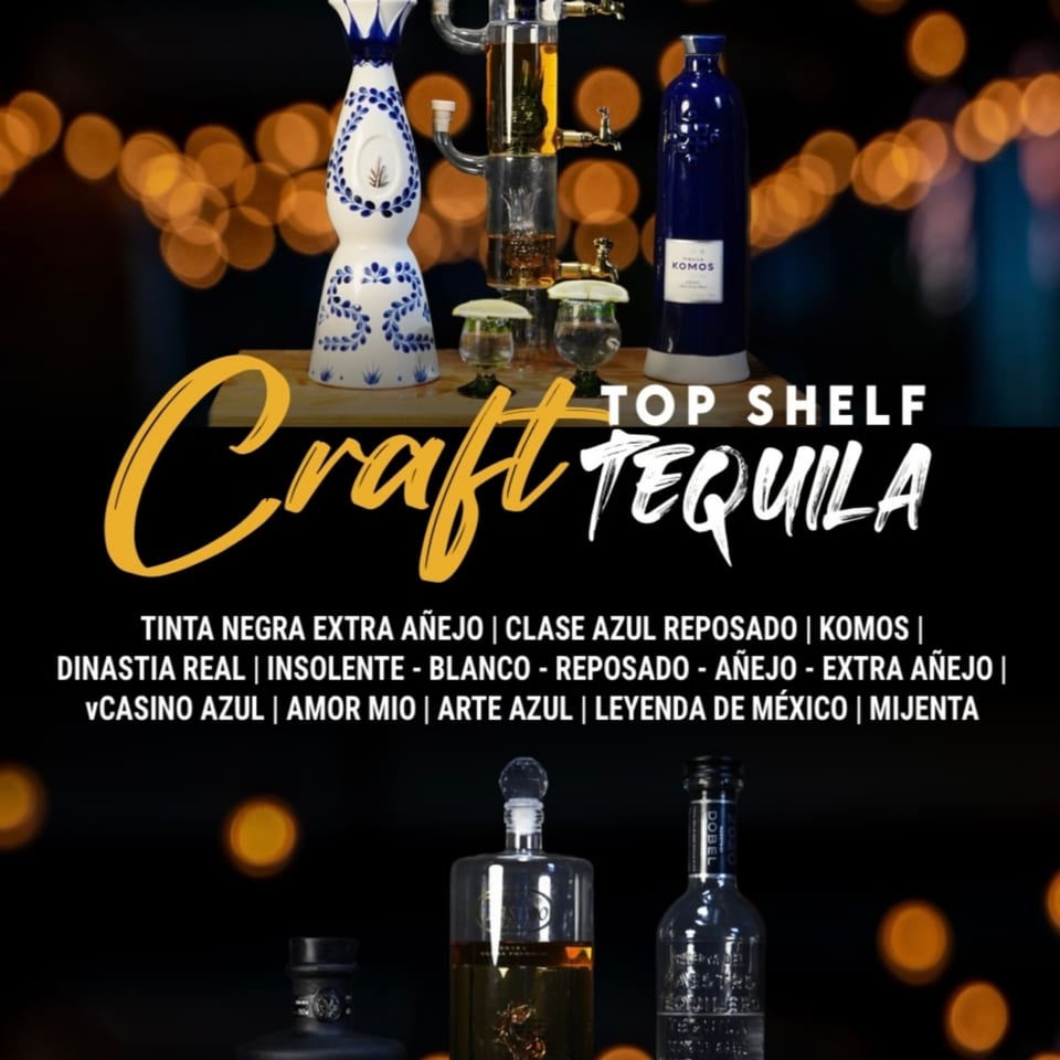 A display of various premium tequila bottles, including Clase Azul and Komos, with festive bokeh lights.