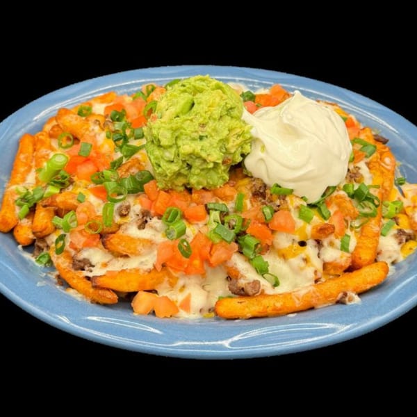 El Mirador 2's Mexican fries topped with melted cheese, ground beef, tomatoes, green onions, guacamole, and sour cream.